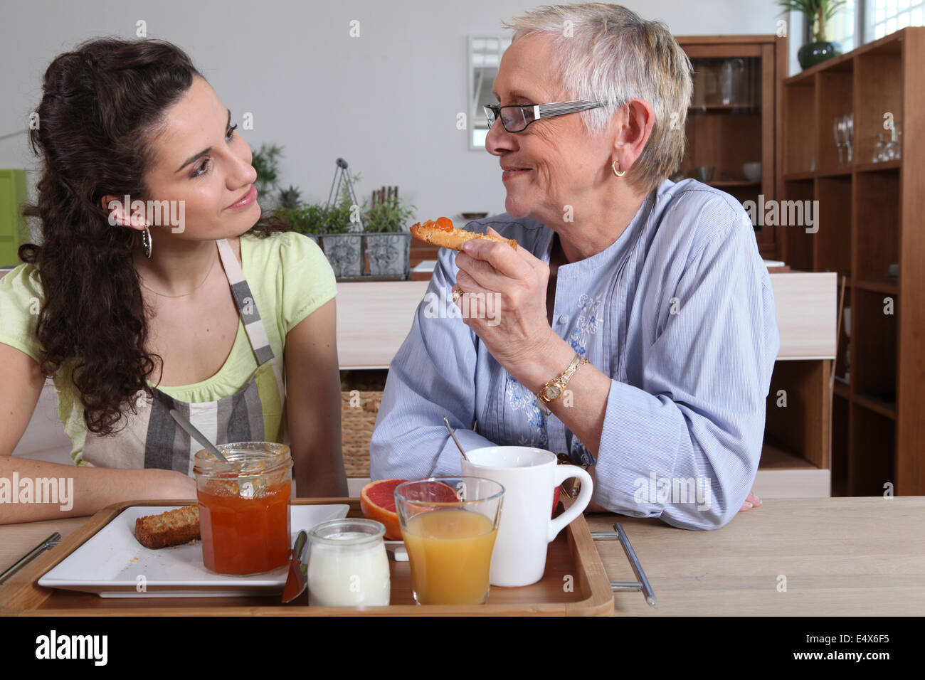 Grandmother and granddaughter having breakfast Stock Photo