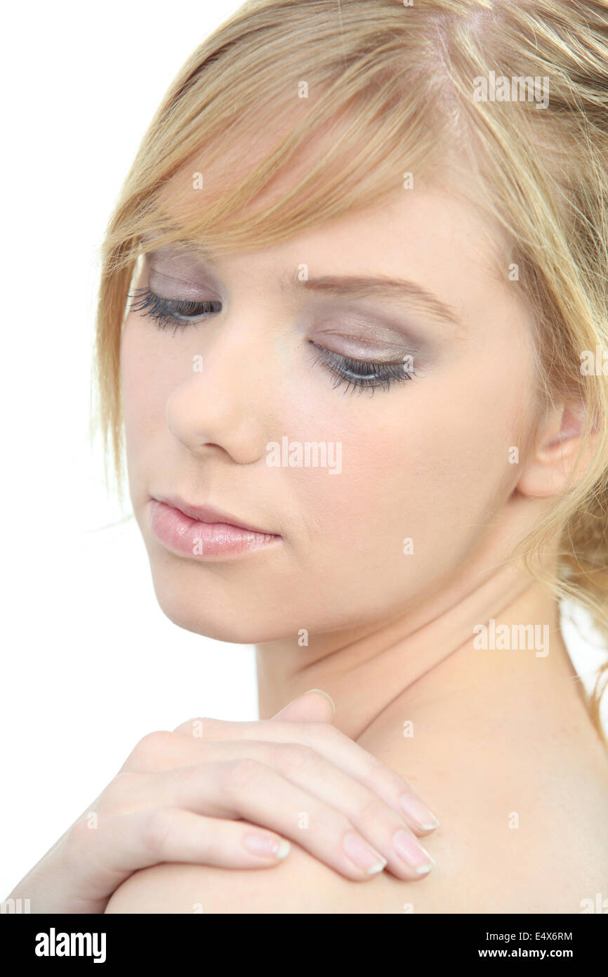 Woman rubbing lotion into her skin Stock Photo Alamy