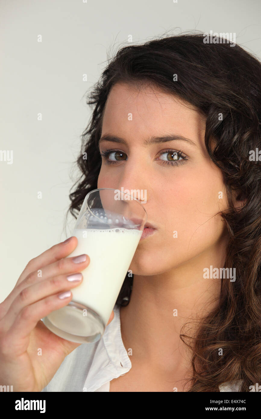 Woman drinking a class of milk Stock Photo