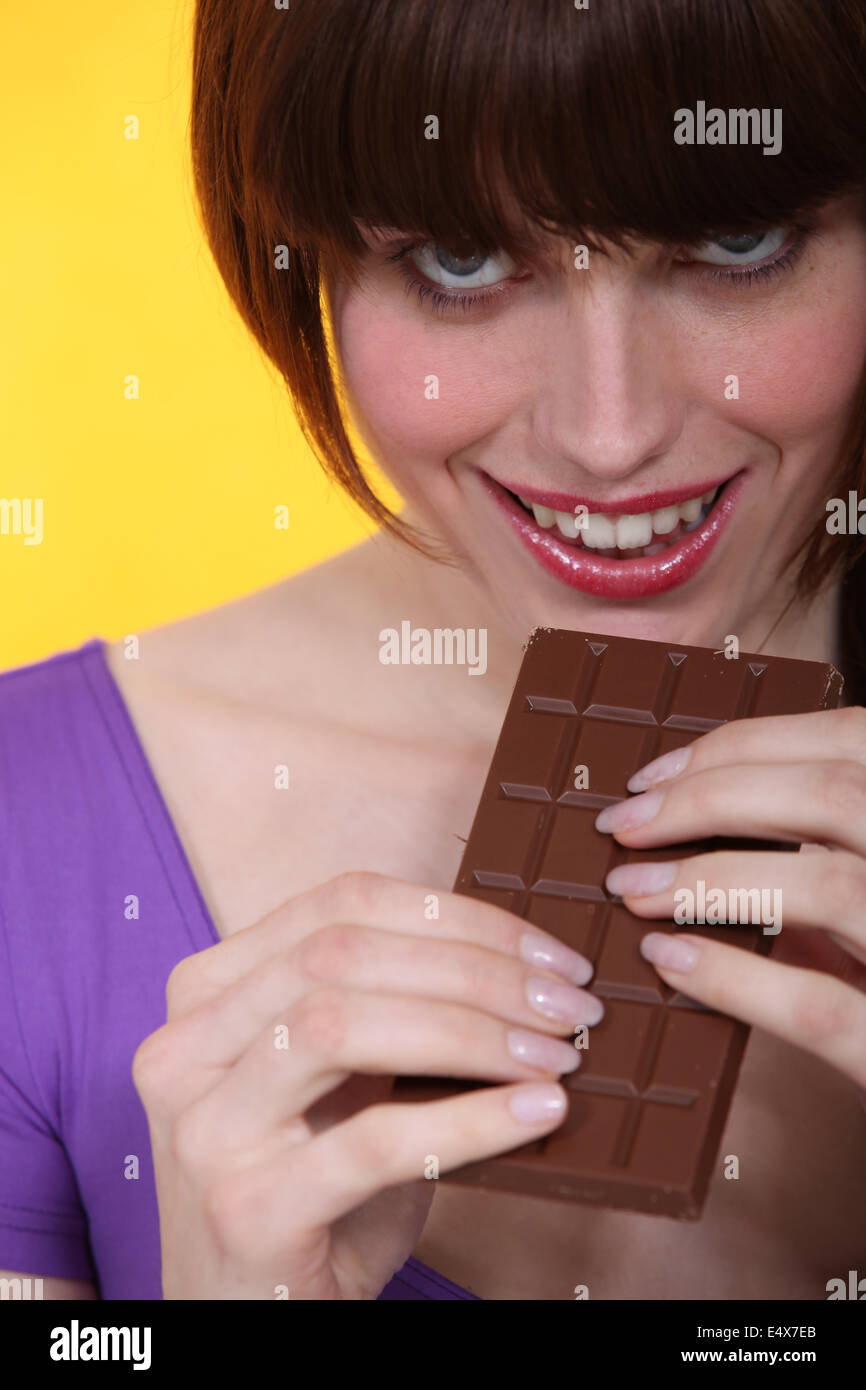 beautiful young woman eating chocolate Stock Photo