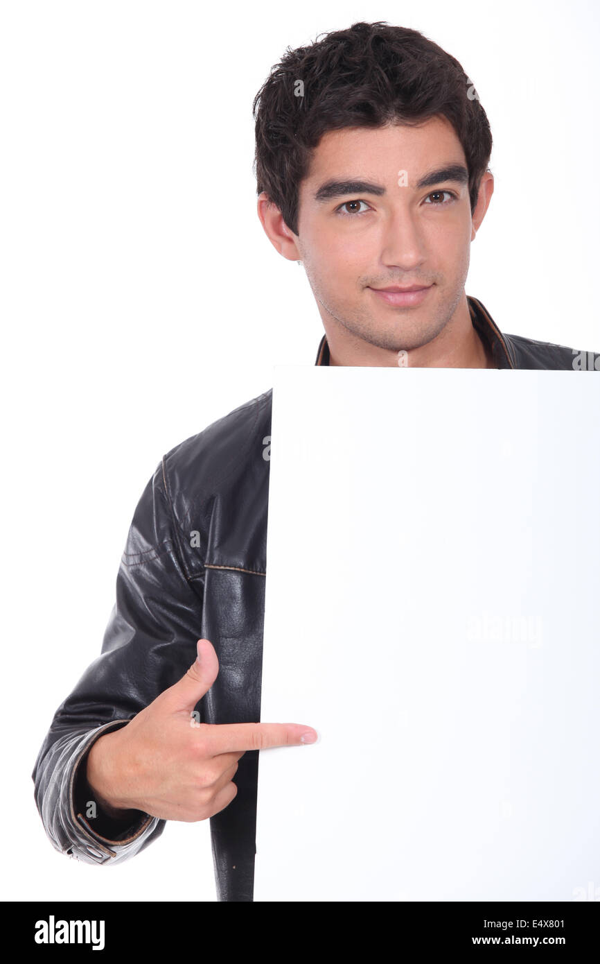 young man pointing white placard Stock Photo
