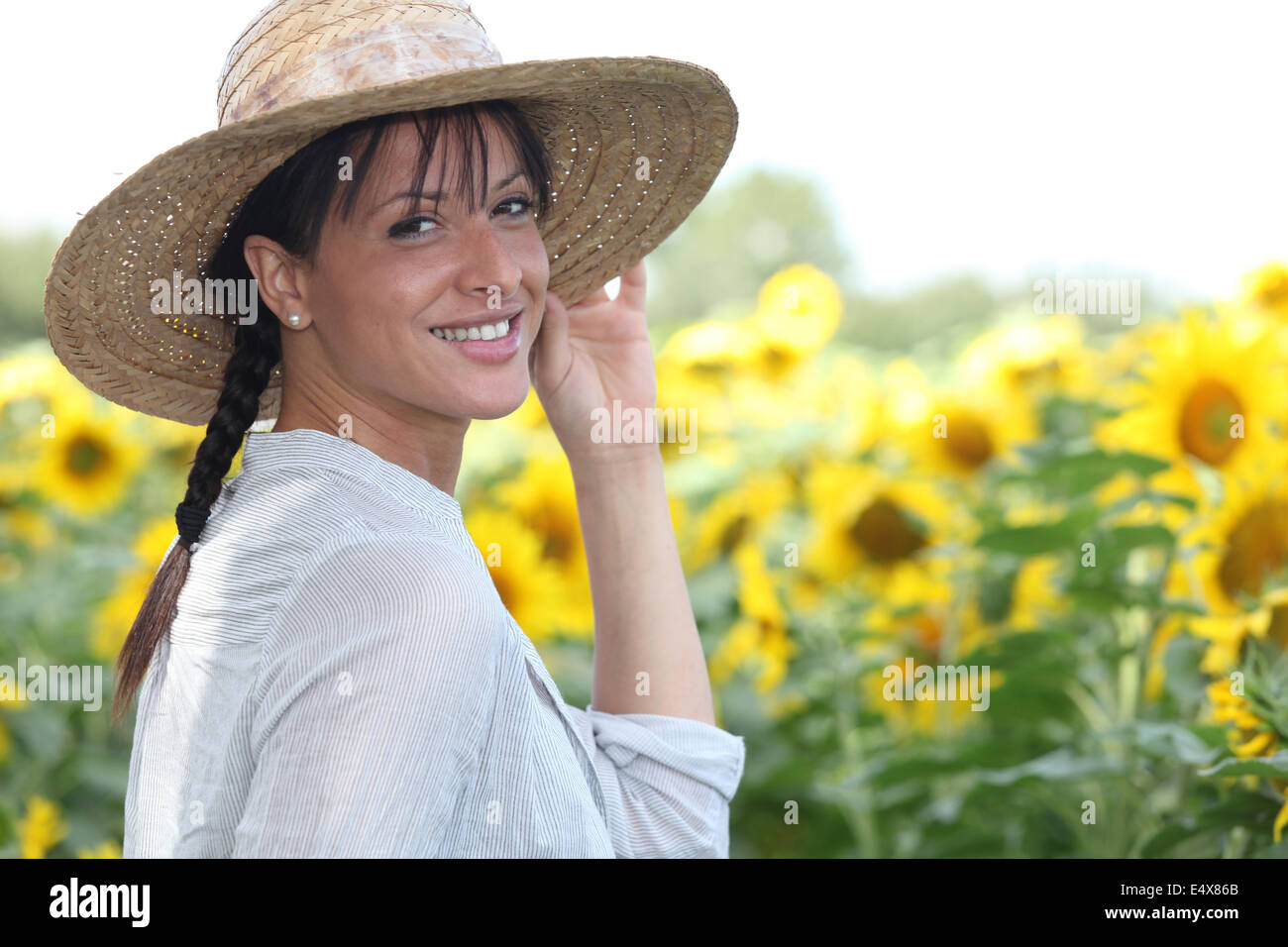 Young woman in a sunflower field Stock Photo - Alamy