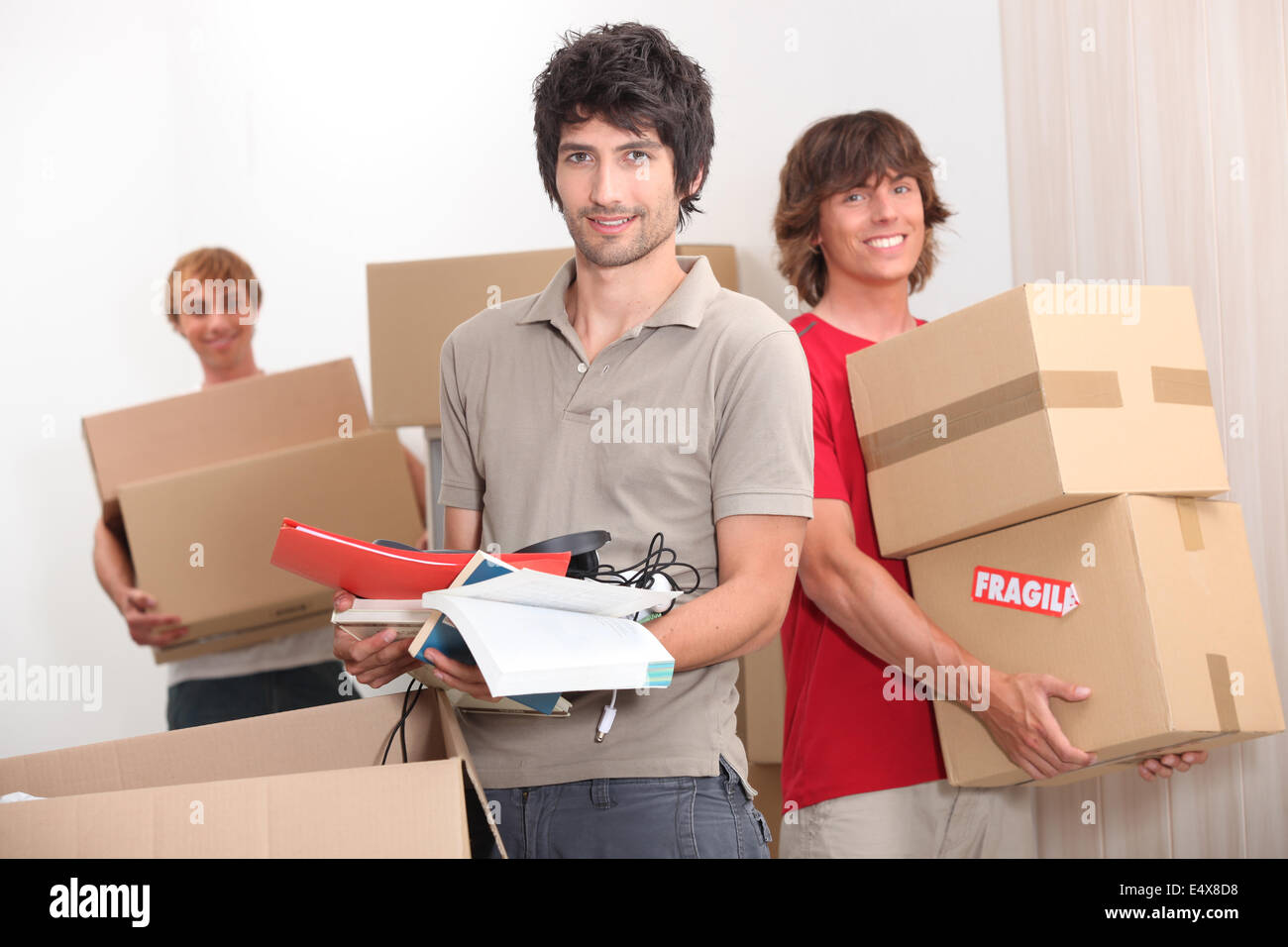 House mates carrying boxes Stock Photo