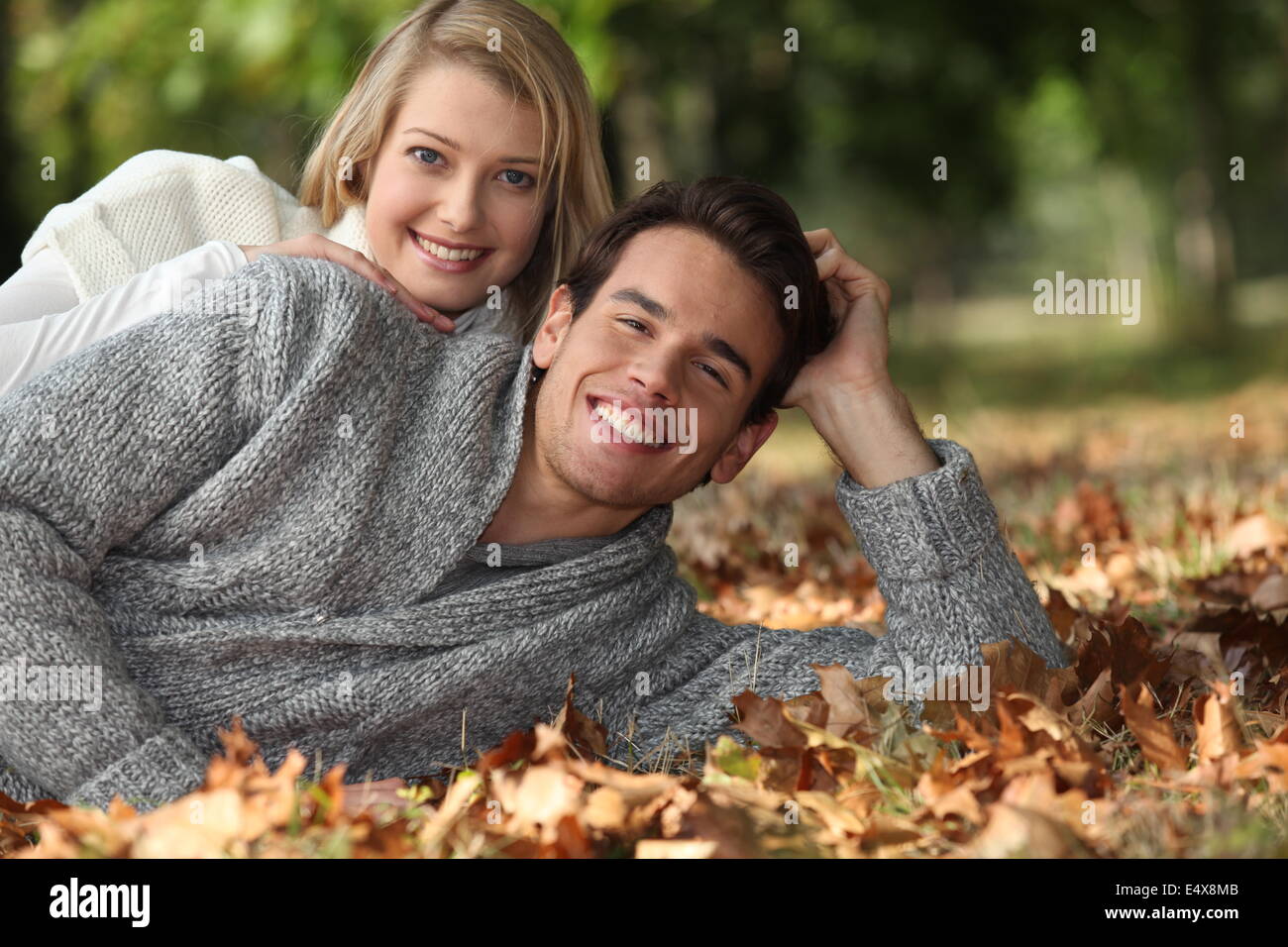 Couple lying in the leaves Stock Photo