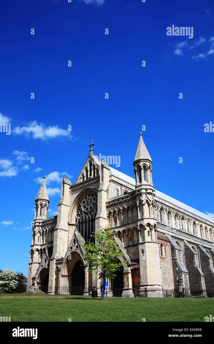 St Albans Cathedral in St Albans, Hertfordshire, England with a blue sky, some clouds and copy space Stock Photo