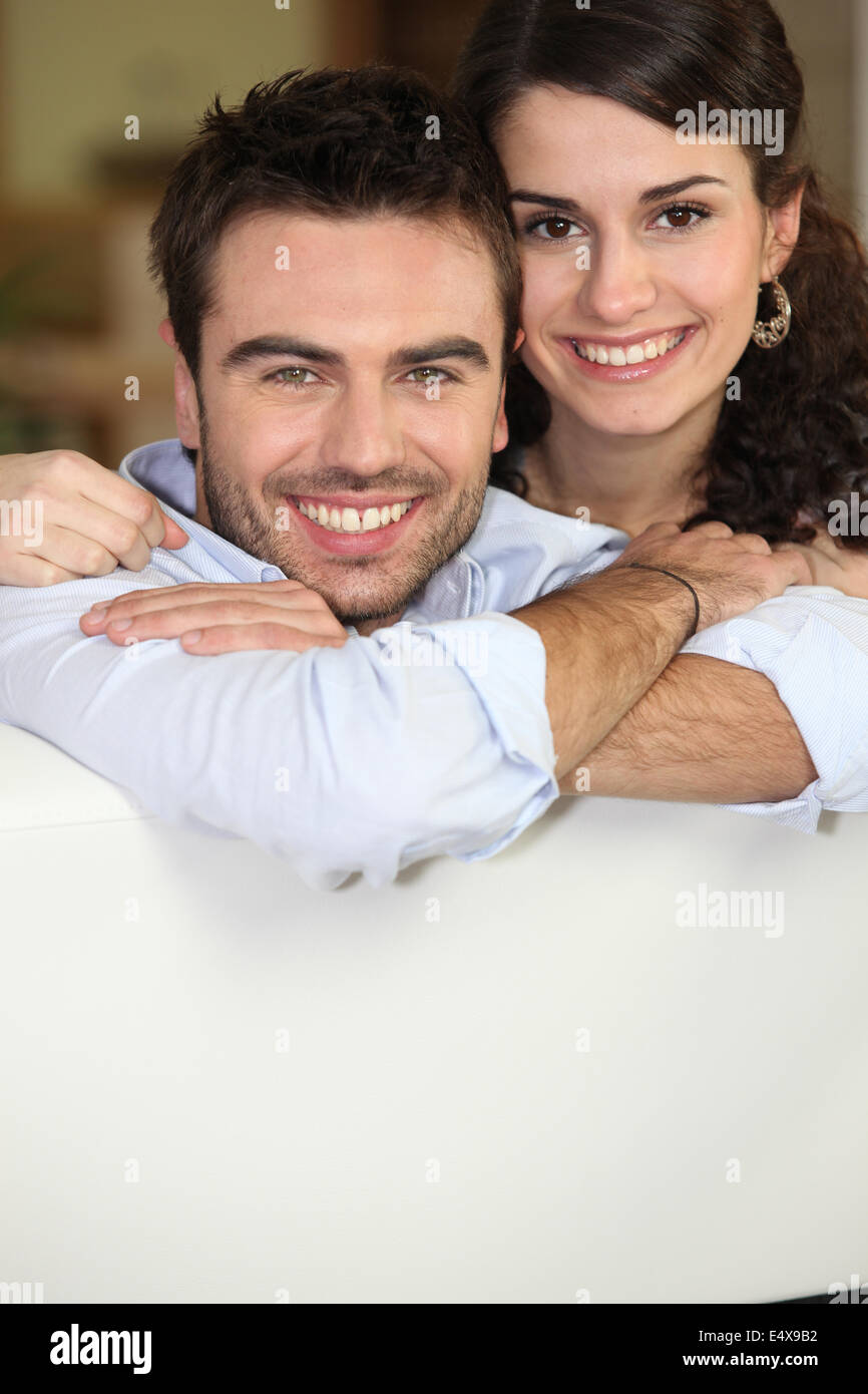 Couple relaxing on sofa Stock Photo - Alamy