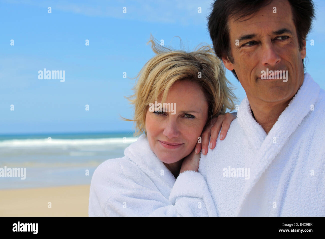 couple in robes on the beach Stock Photo Alamy