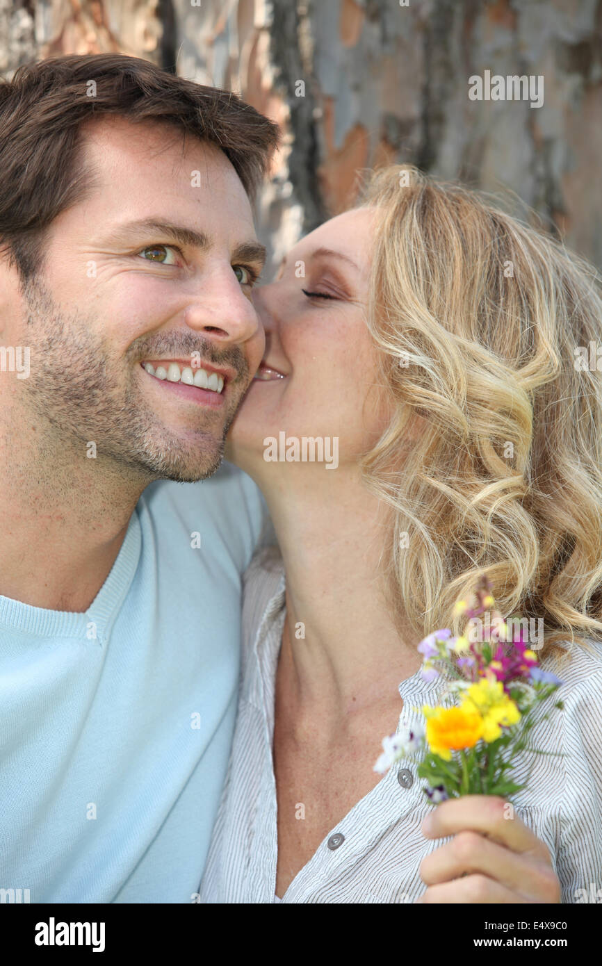 Couple kissing with flowers hi-res stock photography and images - Alamy