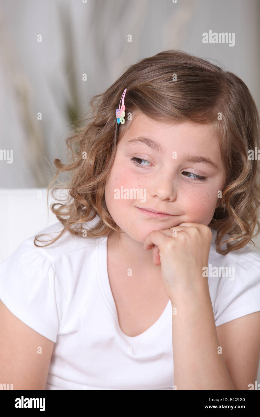 little girl sitting on the sofa Stock Photo - Alamy