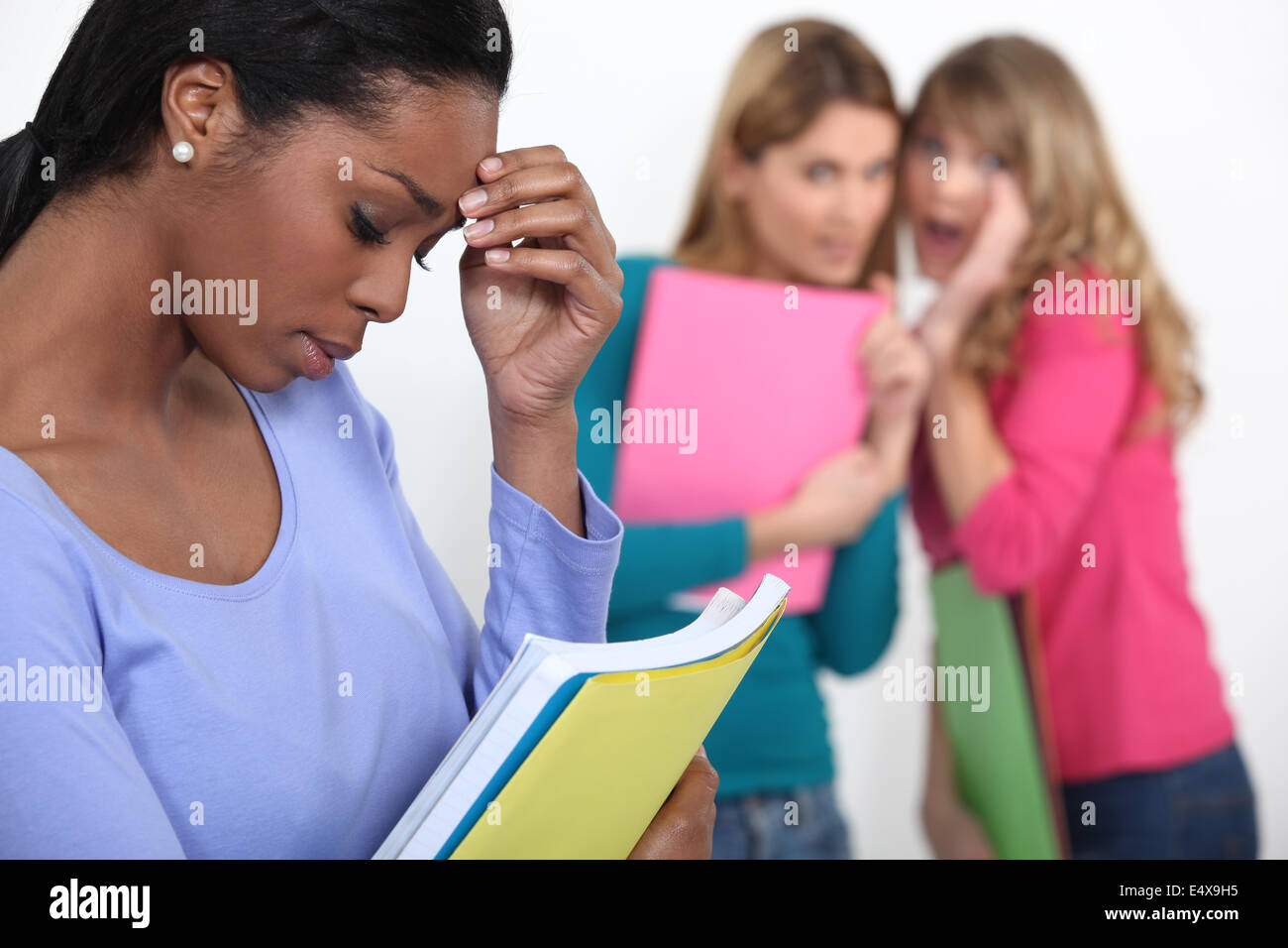 Sad student excluded by friends Stock Photo