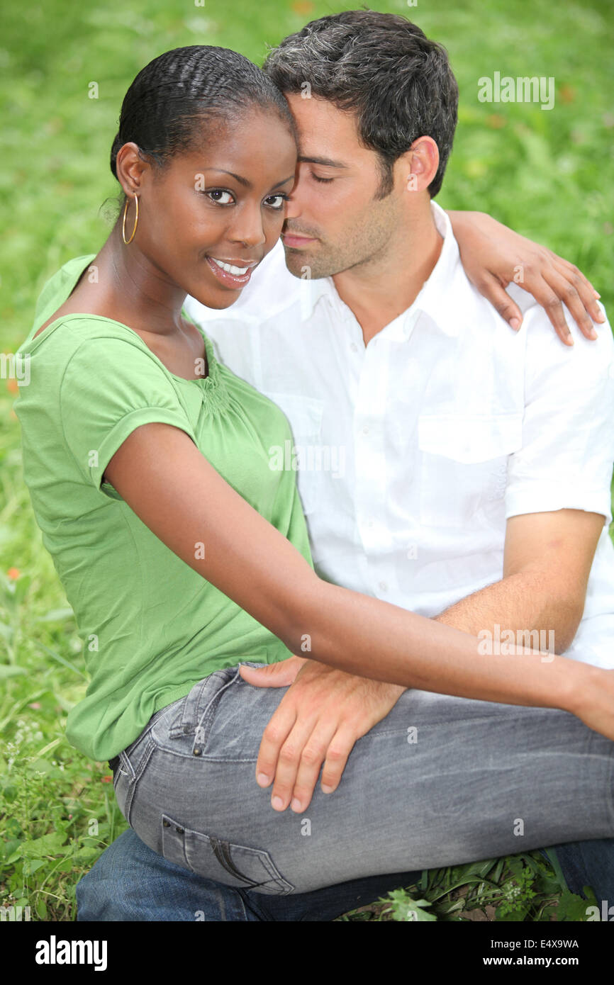Couple sitting on grass Stock Photo
