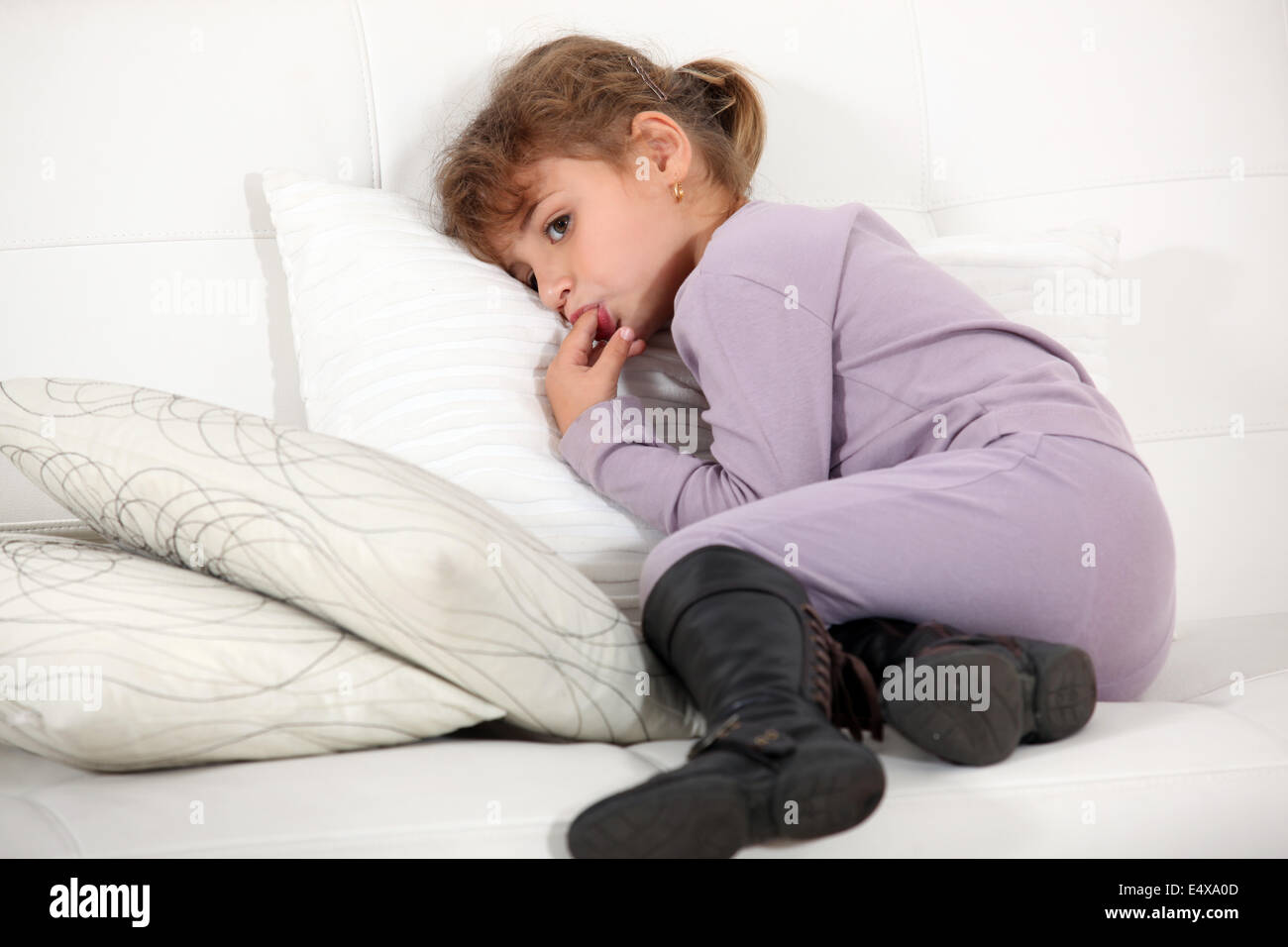 Young girl licking her fingers Stock Photo