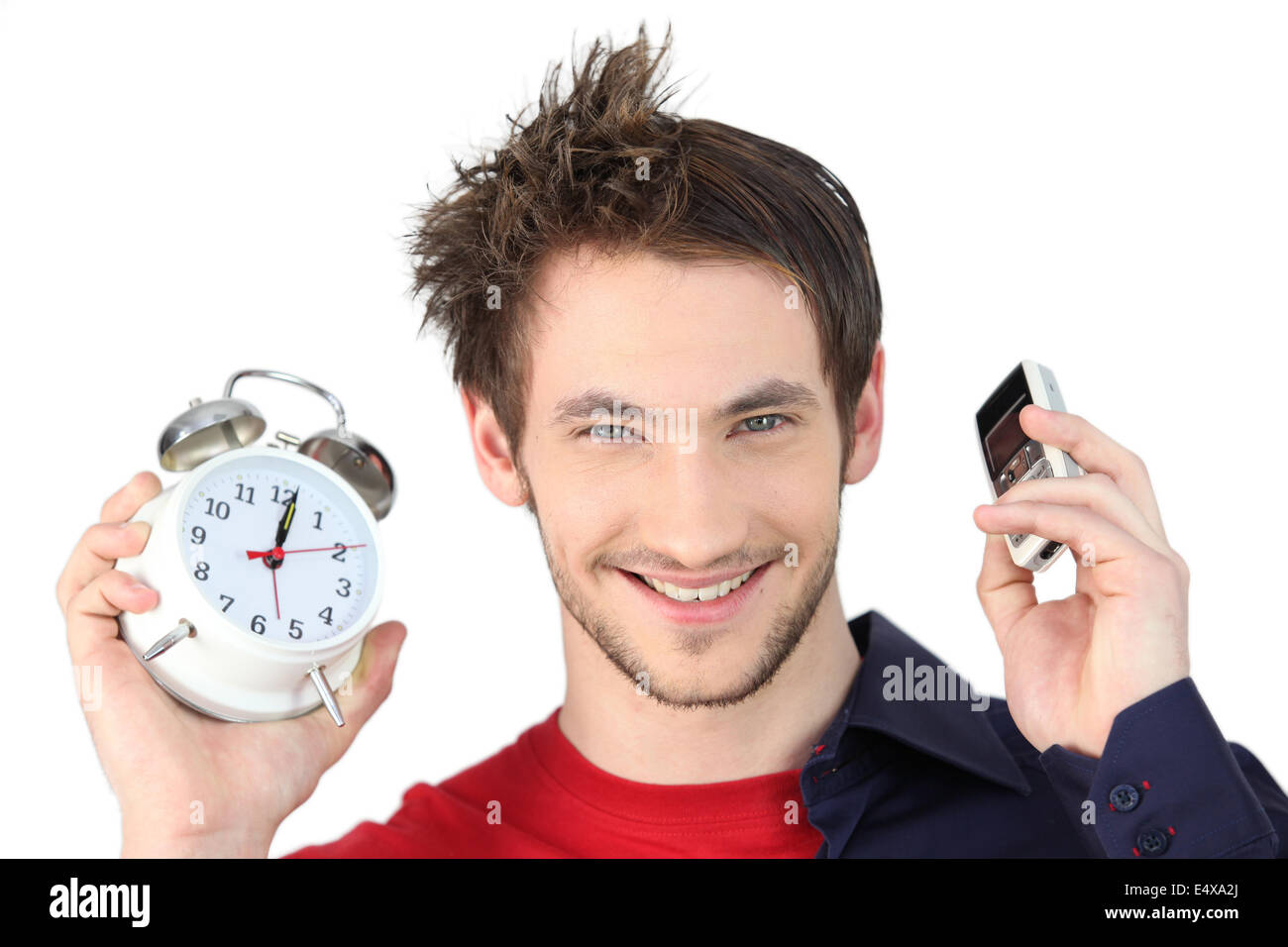 Man holding alarm clock and mobile telephone Stock Photo Alamy
