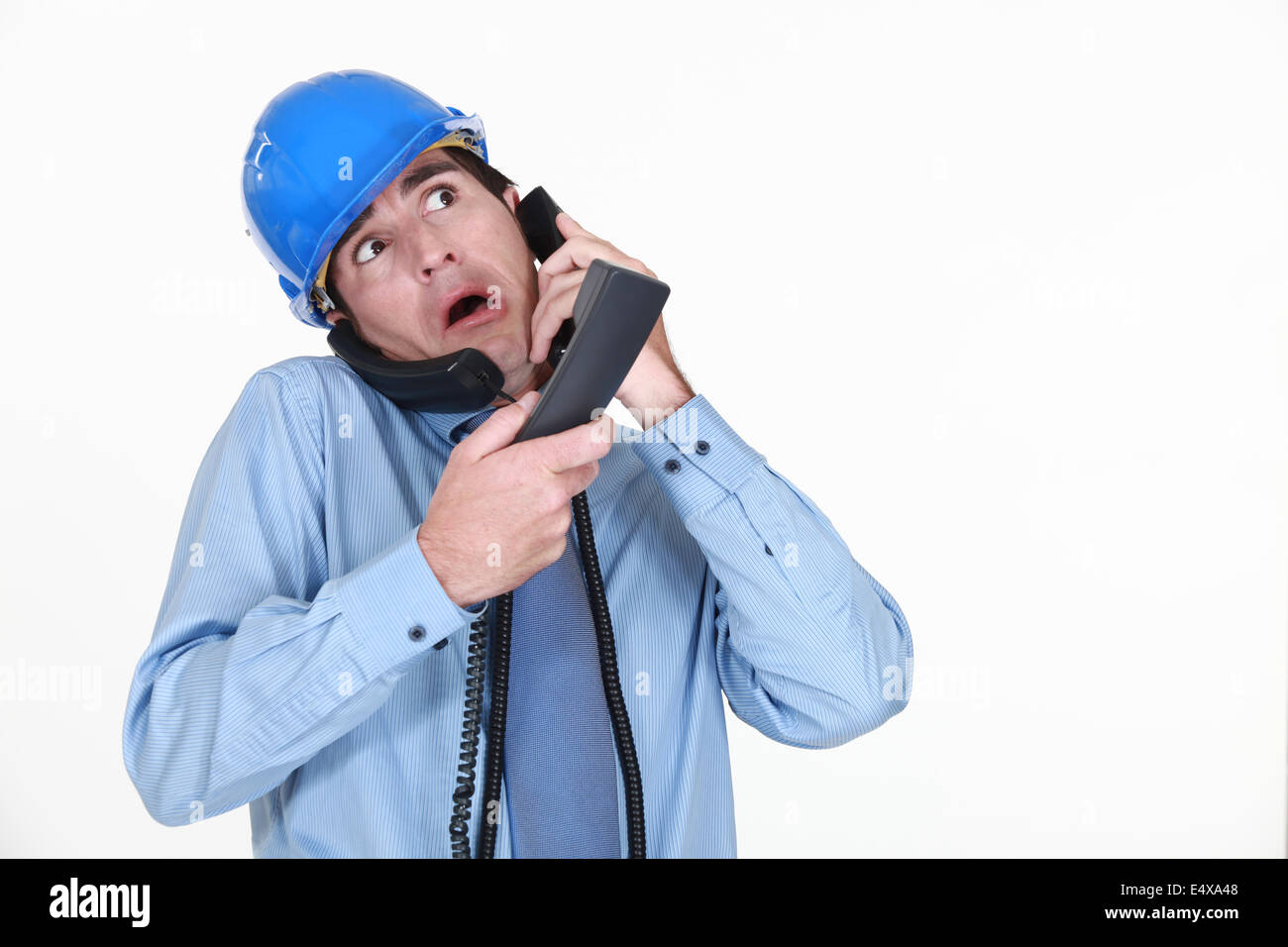Man juggling several phone calls Stock Photo