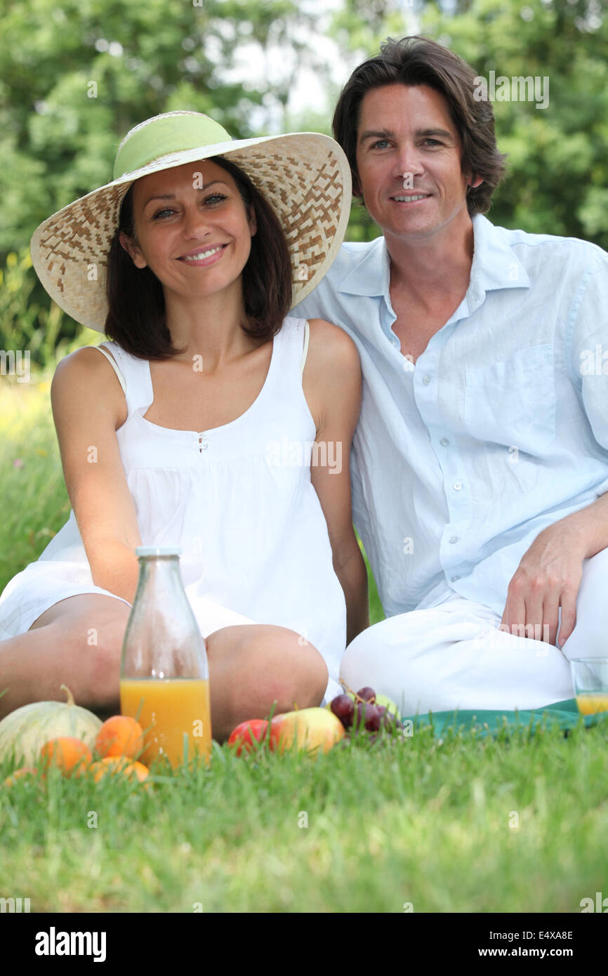 Couple sat on the grass Stock Photo