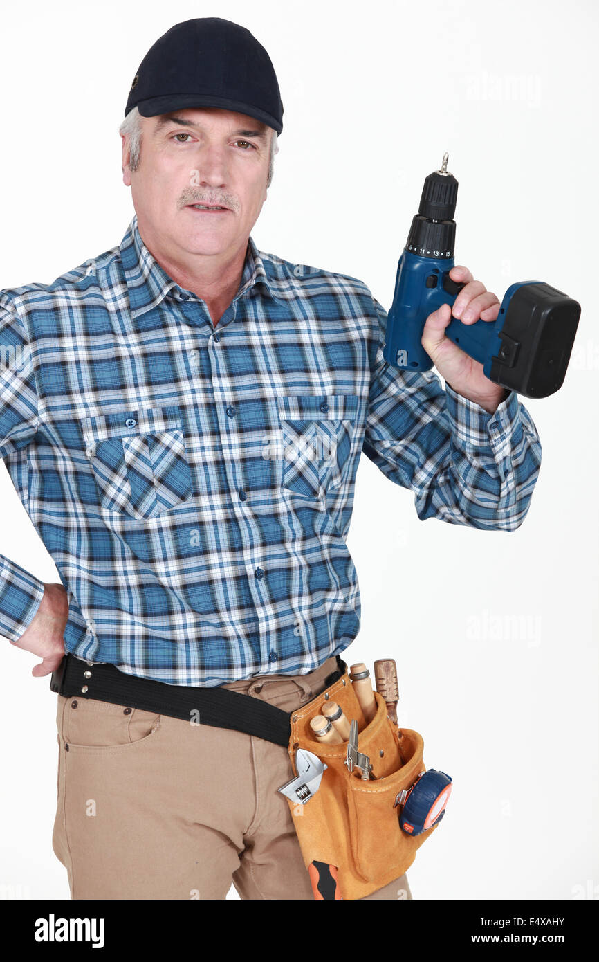 picture of mature carpenter holding drill Stock Photo