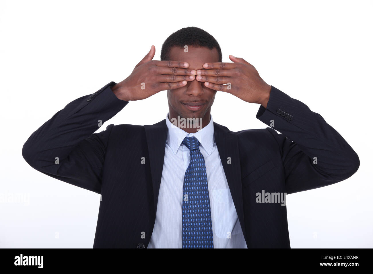 Black man covering his eyes Stock Photo - Alamy