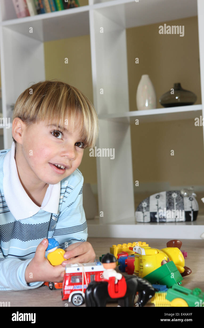 Little boy playing with toys Stock Photo - Alamy