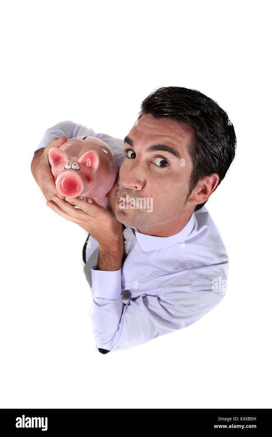 Man holding a piggy bank Stock Photo - Alamy