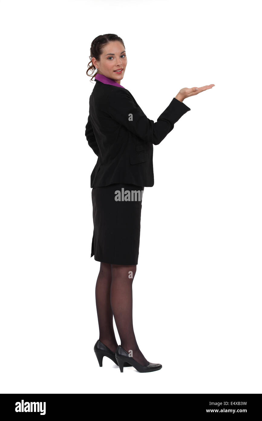 Woman standing holding invisible object Stock Photo