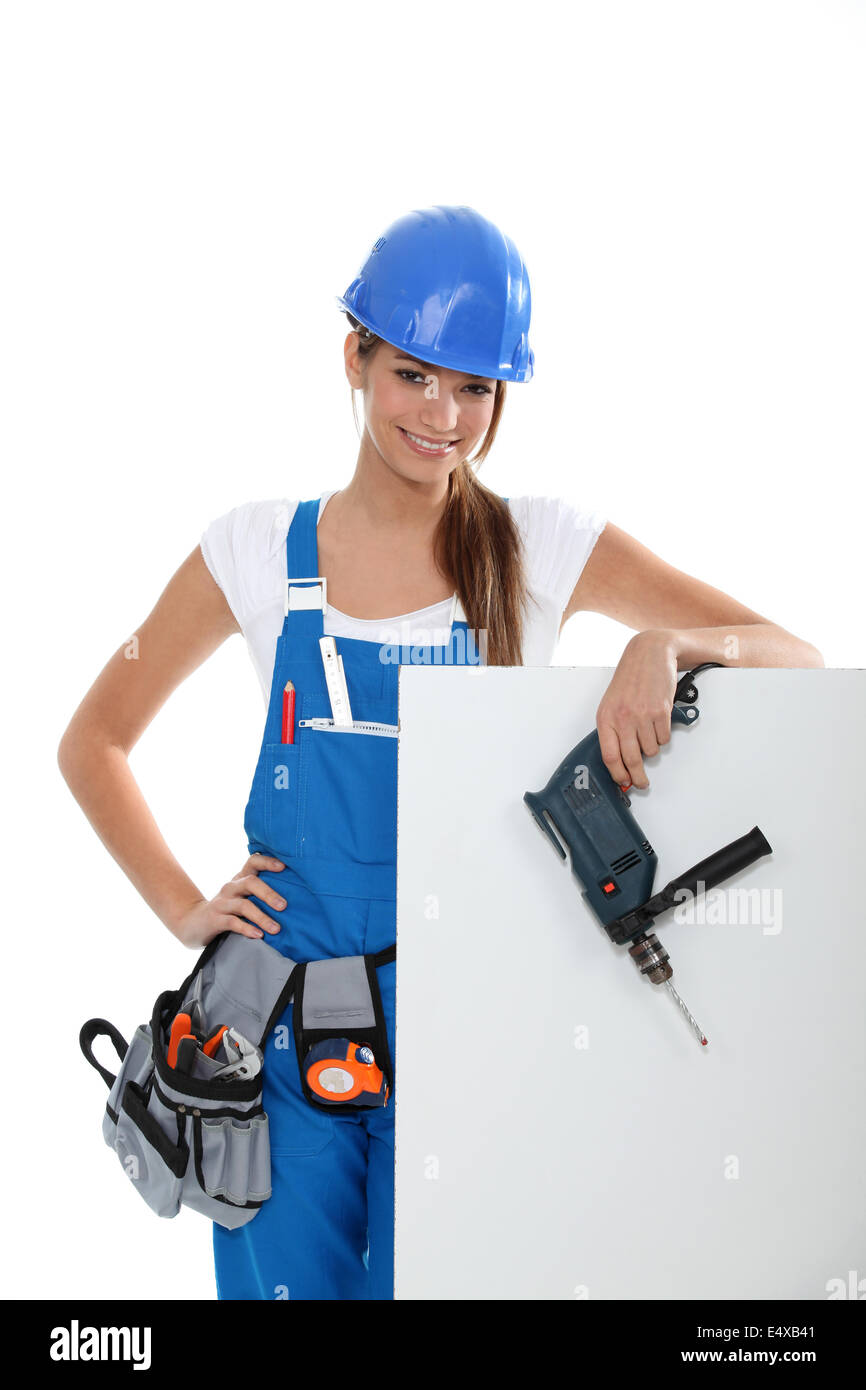Woman with a drill and a blank board Stock Photo