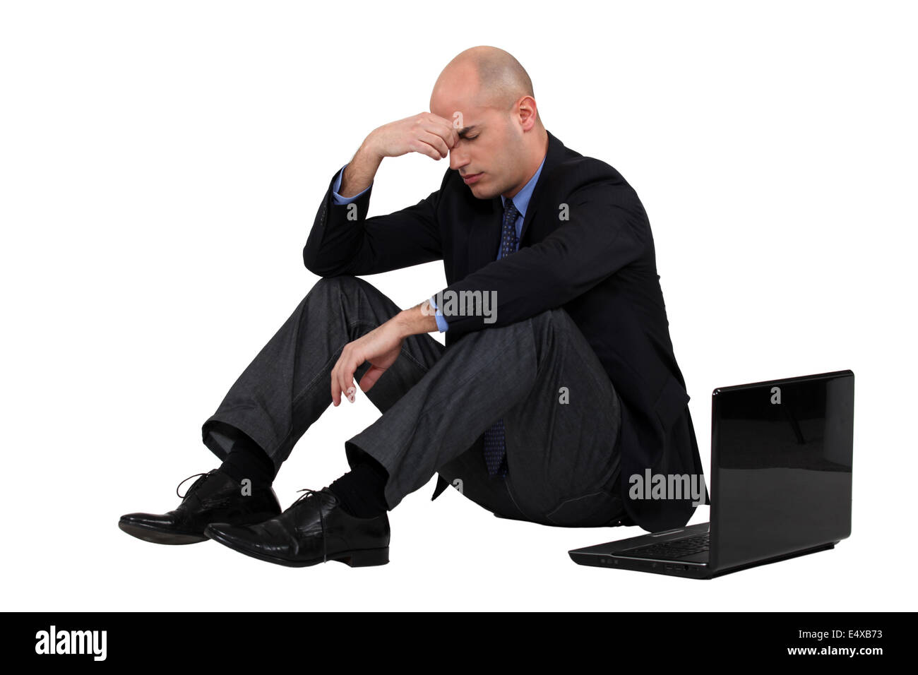 Stressed out businessman with his laptop Stock Photo