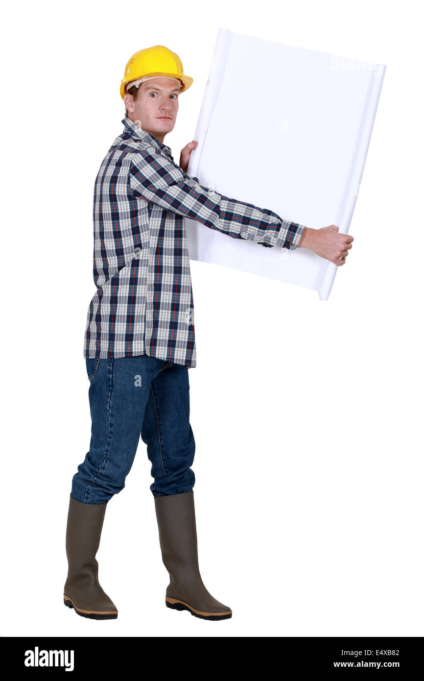 Laborer holding white sheet Stock Photo