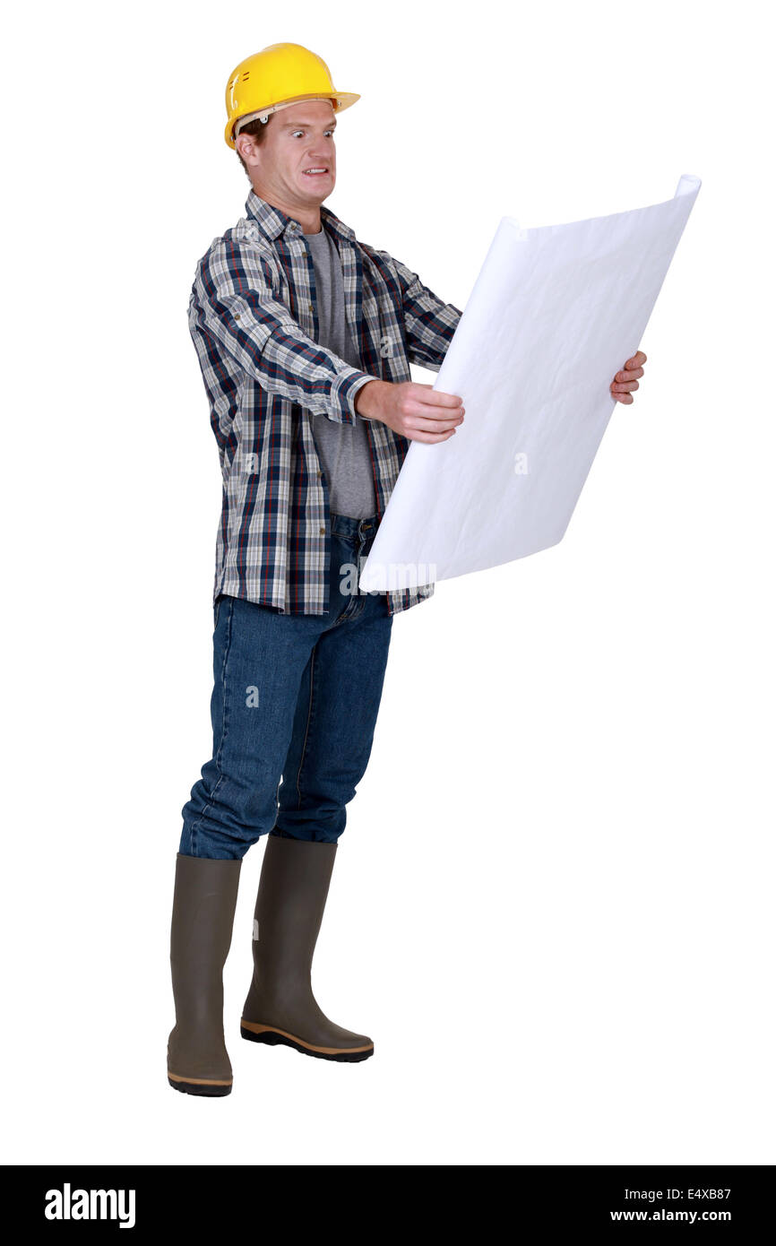 Filing Foreman Foreman examining plans Stock Photo - Alamy