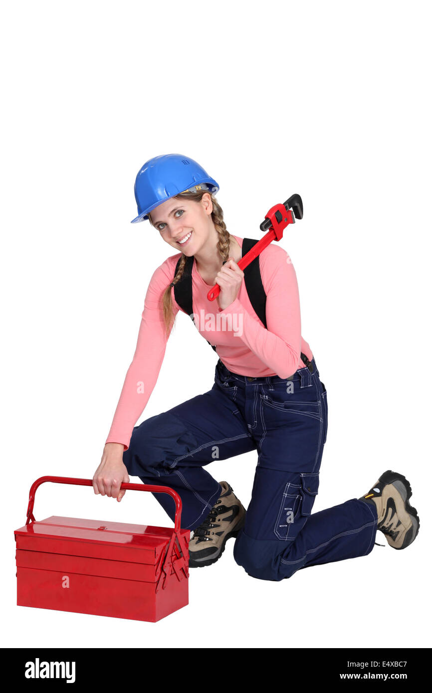 Woman kneeling by tool box Stock Photo