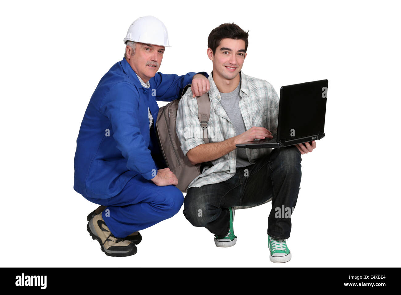 A tradesman helping his apprentice Stock Photo
