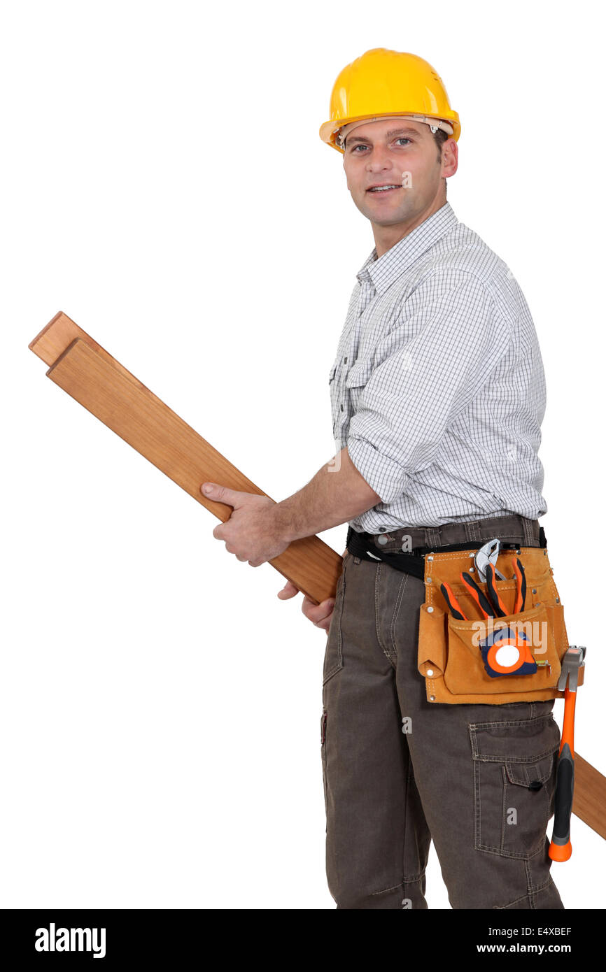 Tradesman carrying planks of wood Stock Photo