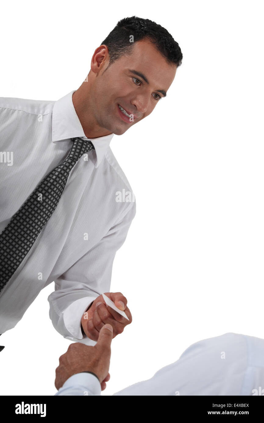 Businessman handing over his card Stock Photo