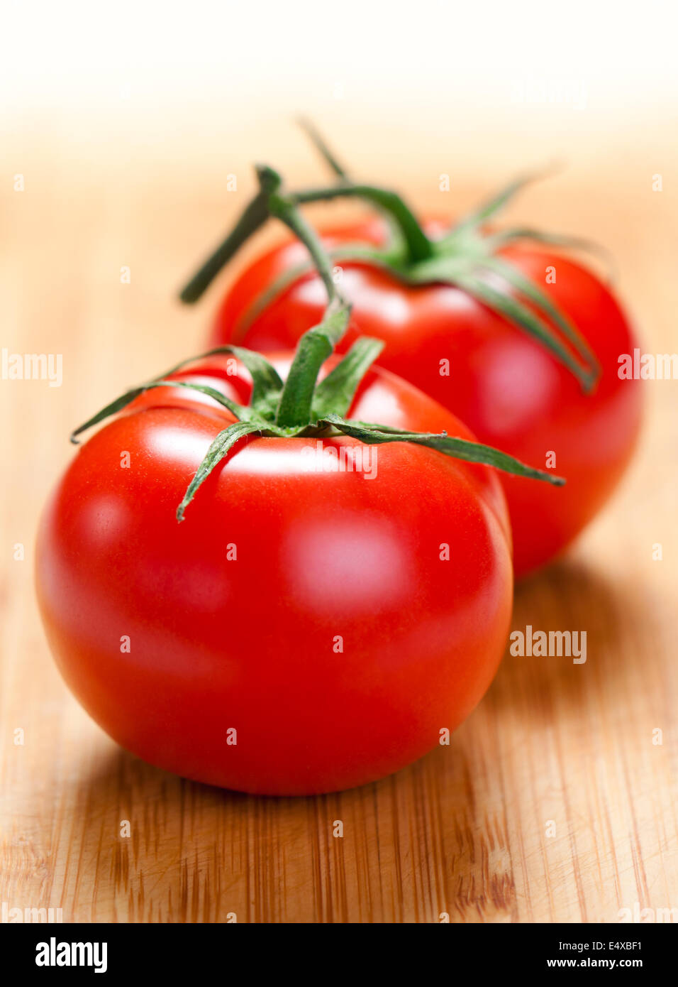 Two tomatoes on the board. Stock Photo
