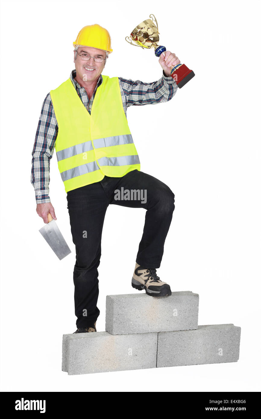 Successful laborer on a podium Stock Photo