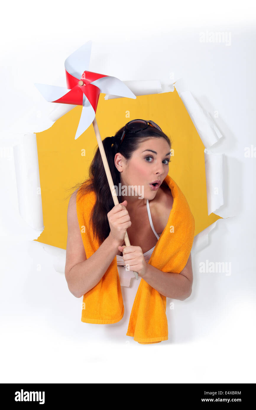 Woman holding toy windmill Stock Photo