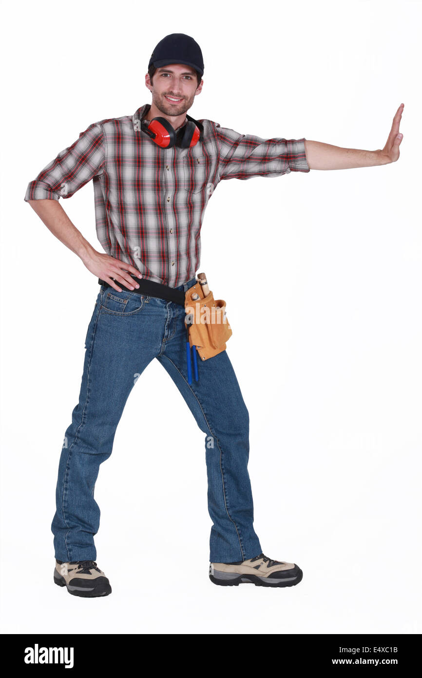 Tradesman pushing an invisible wall Stock Photo