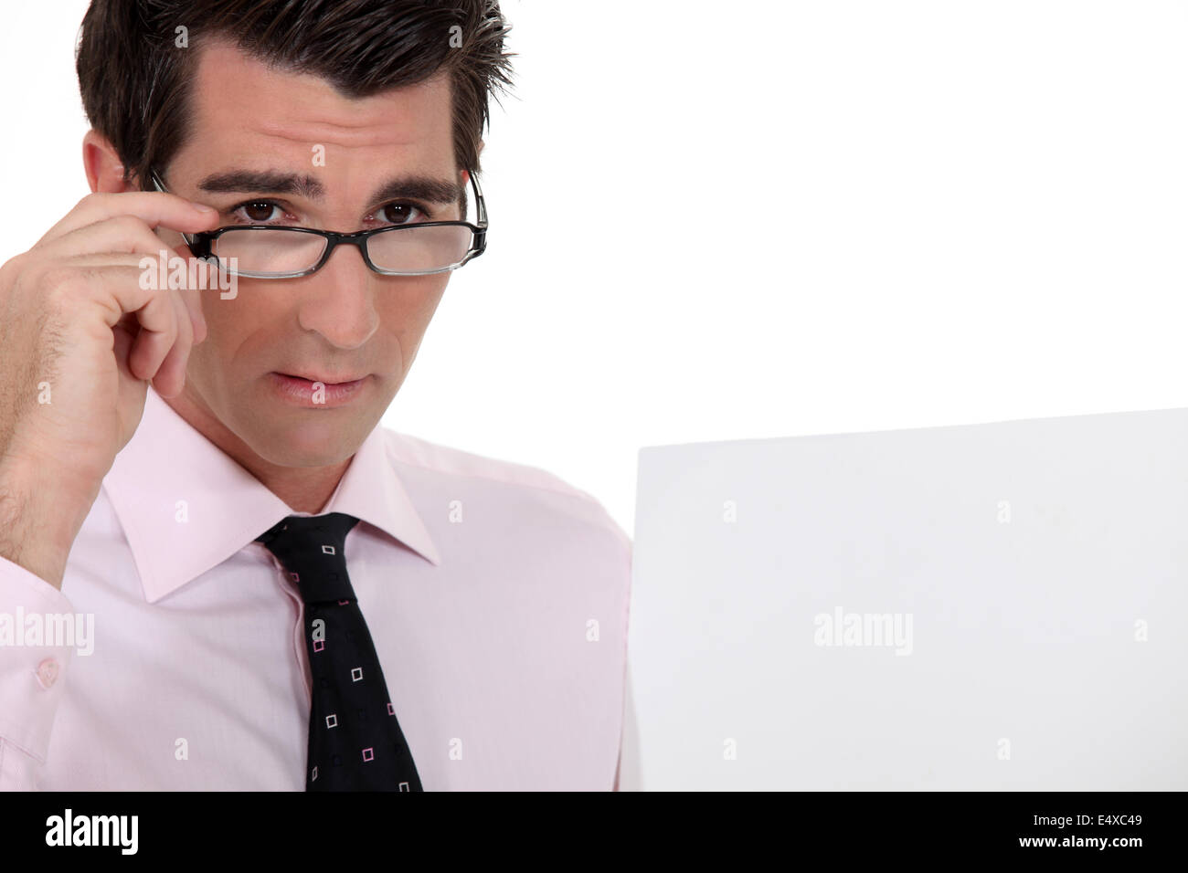 Businessman holding his glasses Stock Photo