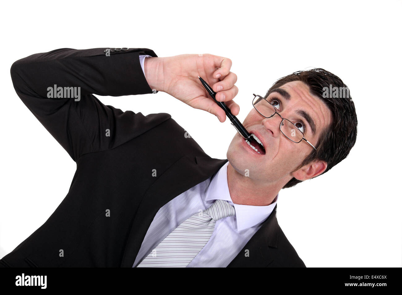 Businessman chewing his pen Stock Photo
