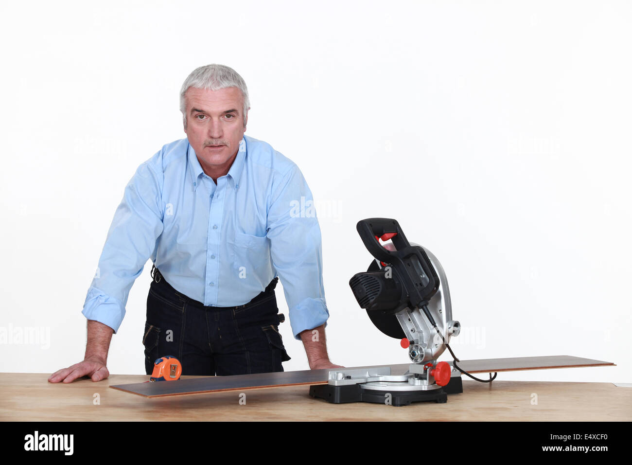 Grey-haired man with circular saw Stock Photo