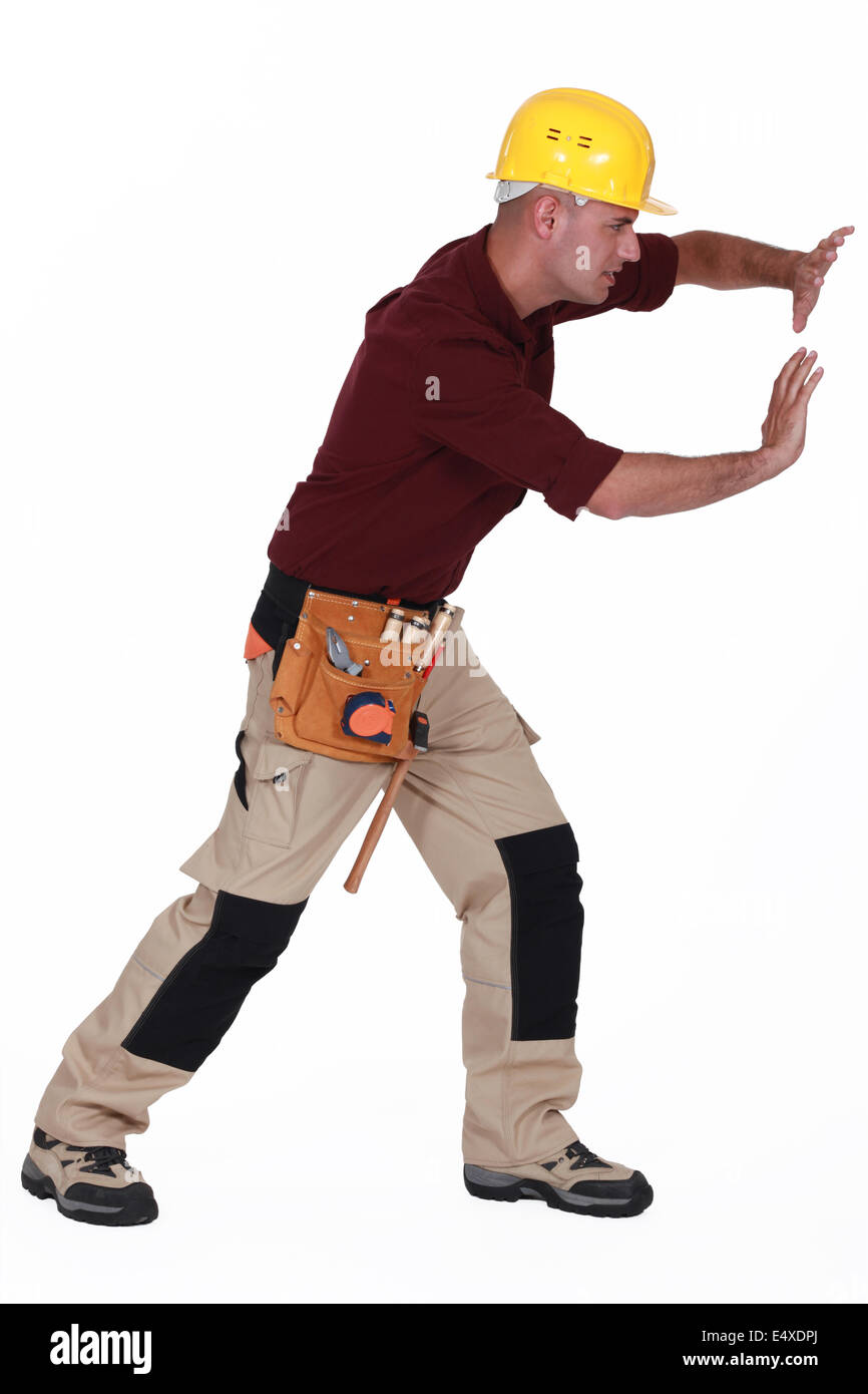 Tradesman pushing an invisible wall Stock Photo