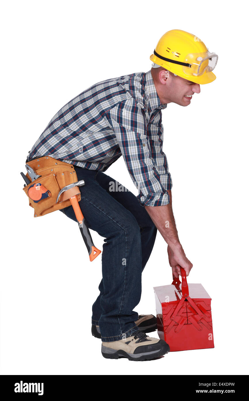 Worker with a heavy tool box Stock Photo