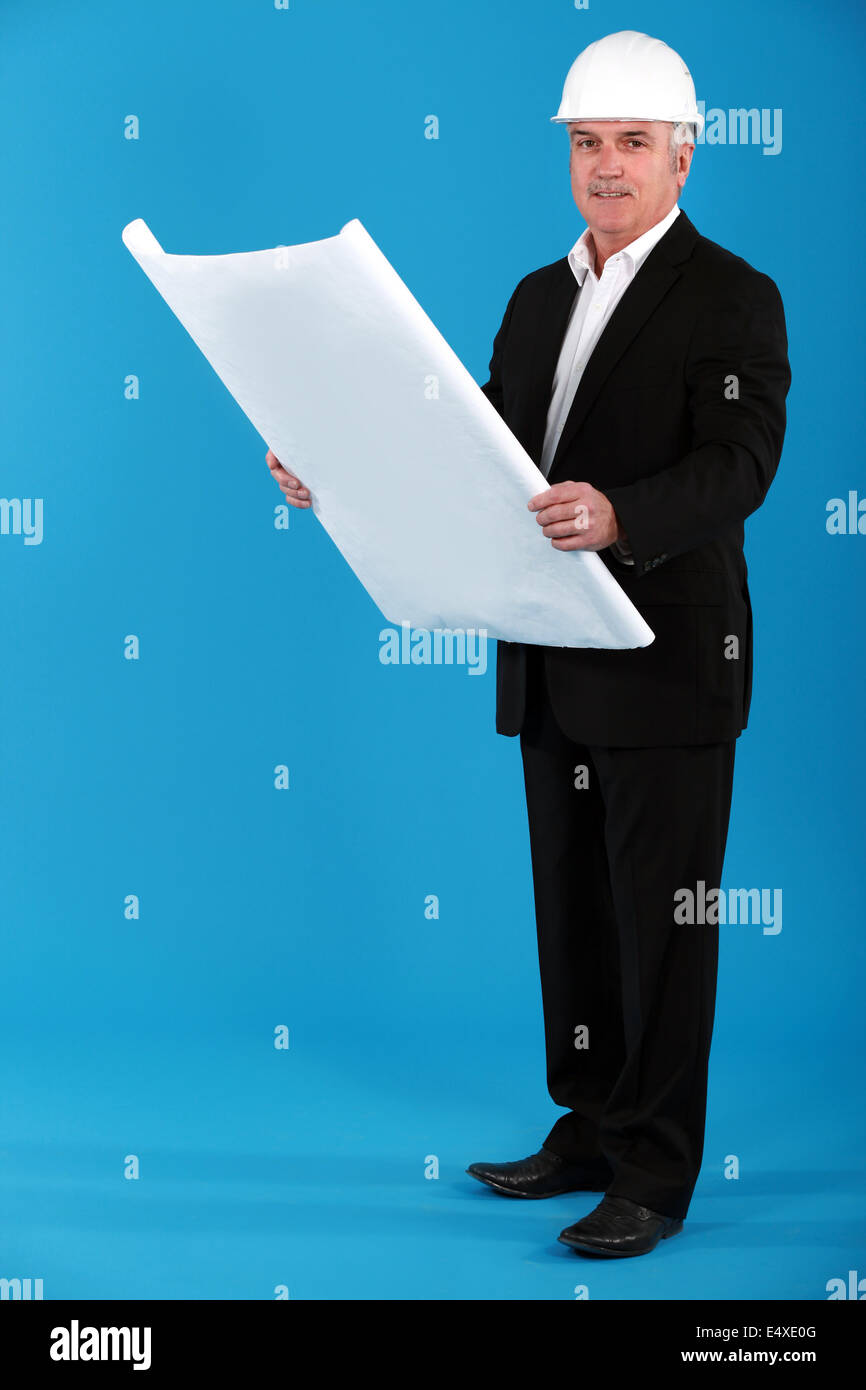 Architect standing on blue background Stock Photo