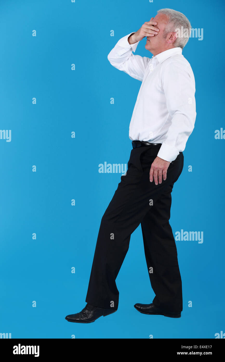 Senior man covering his eyes with his hand Stock Photo - Alamy