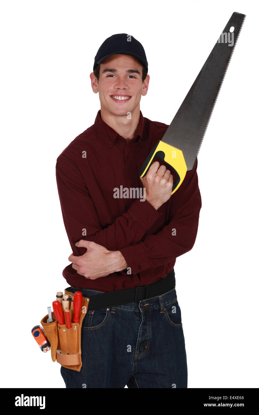 Young tradesman holding a saw Stock Photo