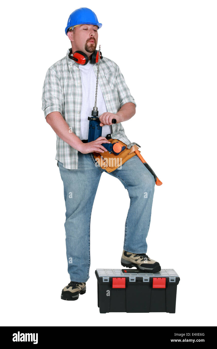 Tradesman blowing on his screwdriver Stock Photo