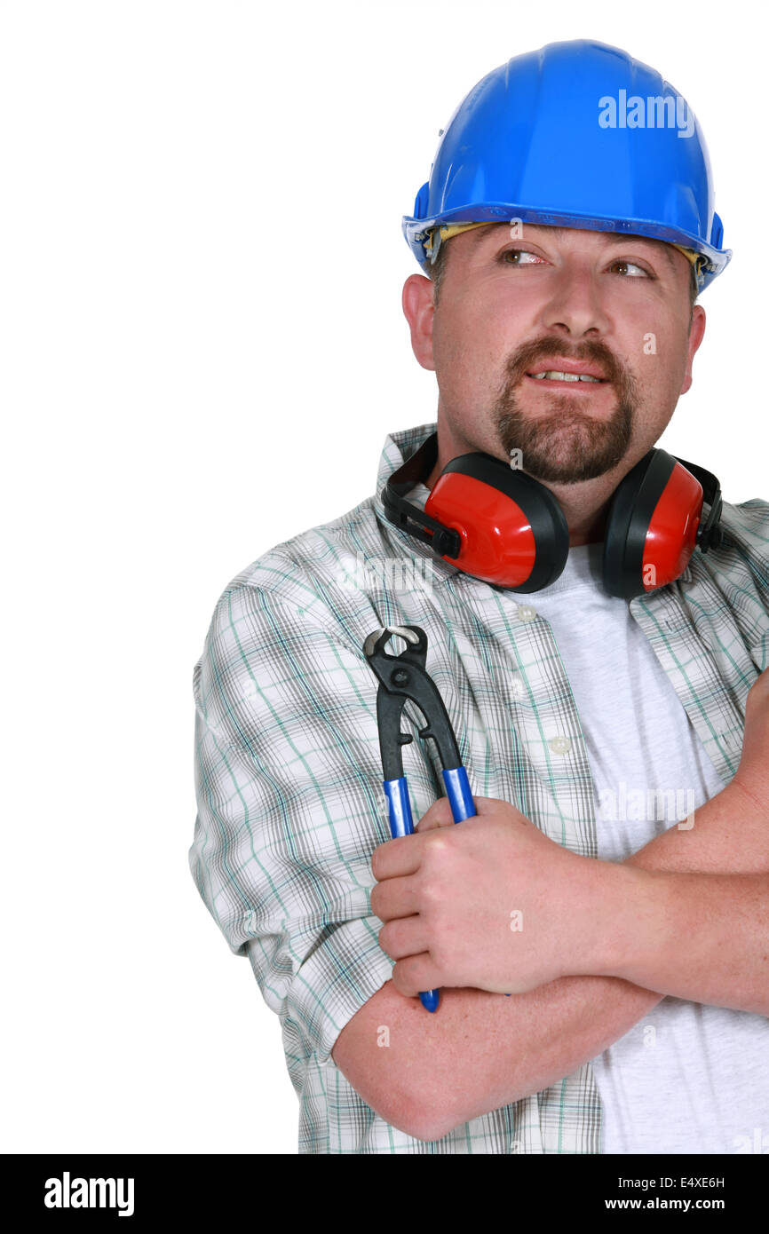 Tradesman holding a pair of pliers Stock Photo