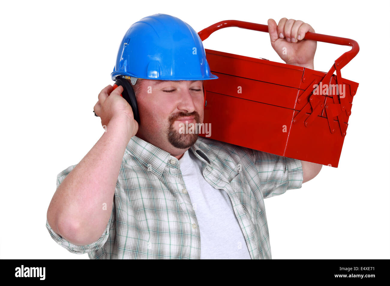 Tradesman pretending to listen to music Stock Photo
