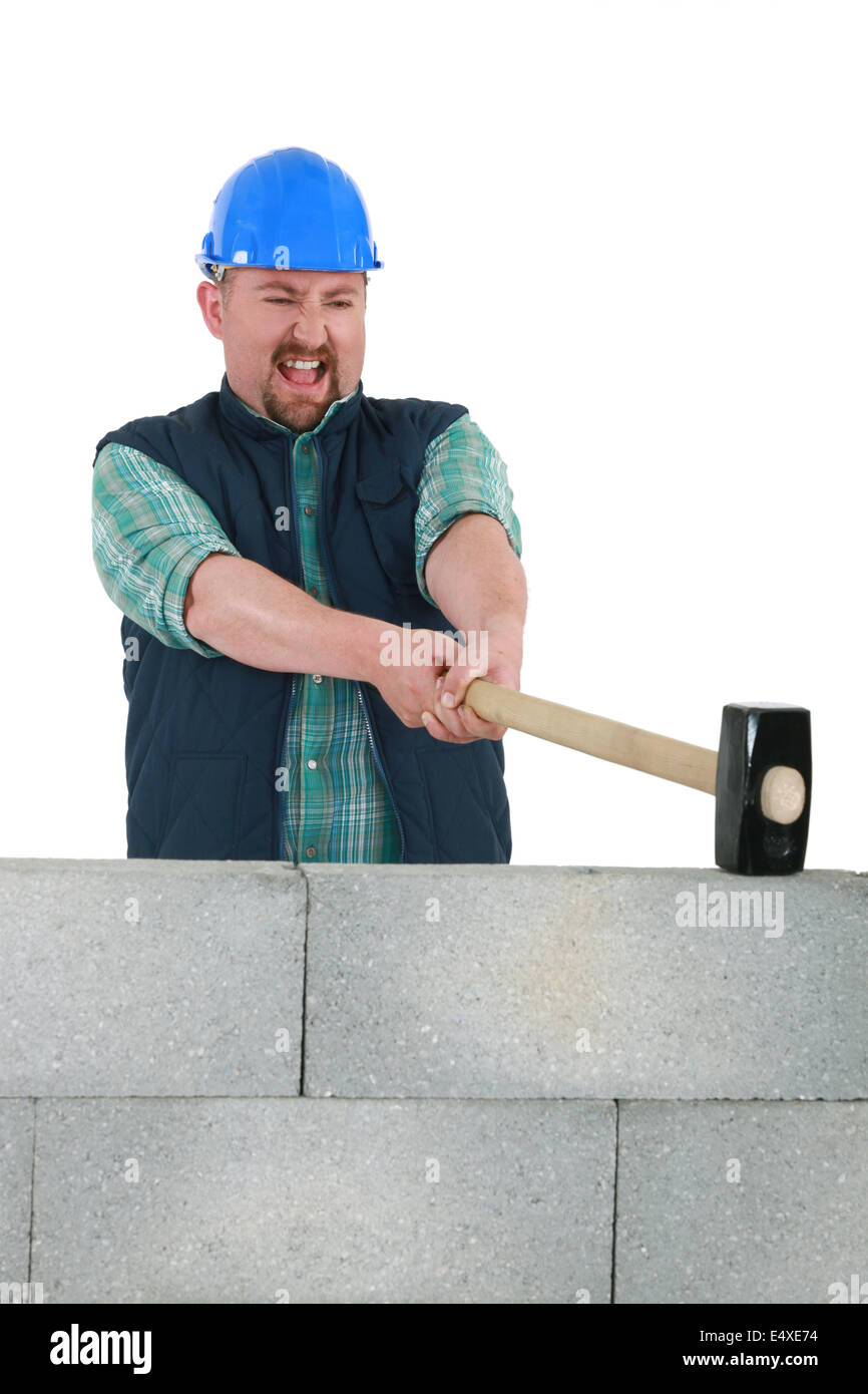 Man hitting wall with sledgehammer hi-res stock photography and