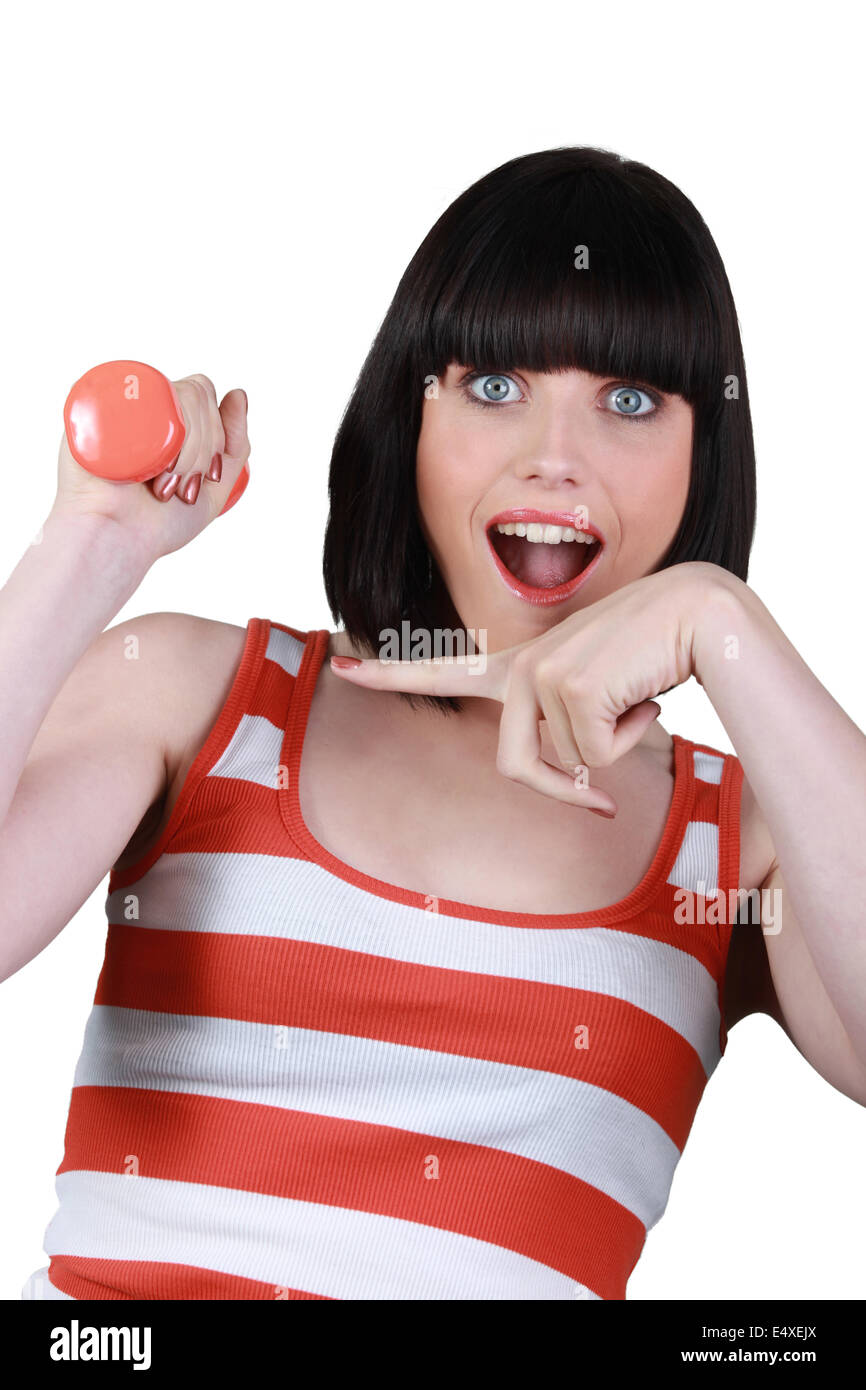 Woman lifting a dumbbell Stock Photo