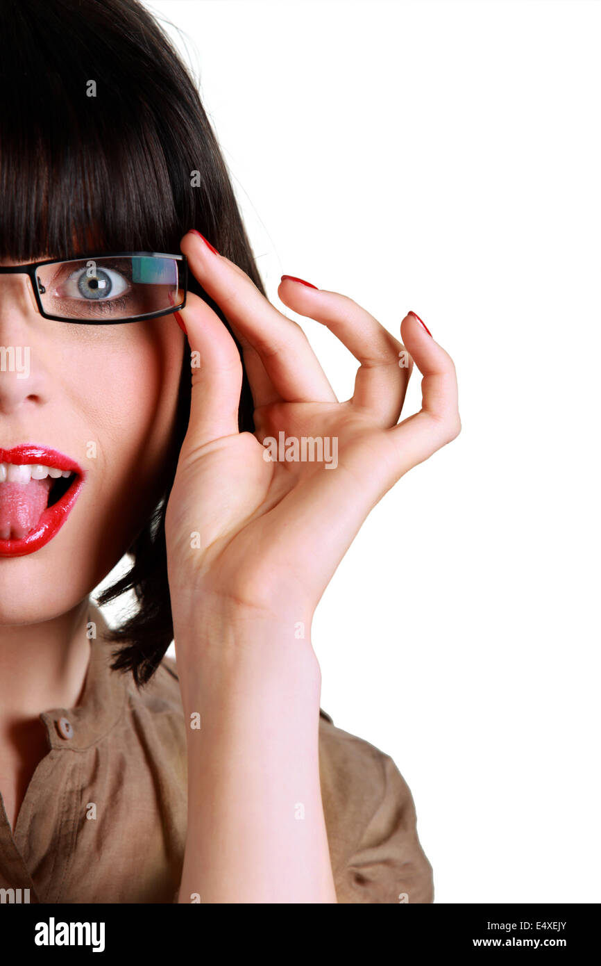 Woman with glasses sticking out her tongue Stock Photo